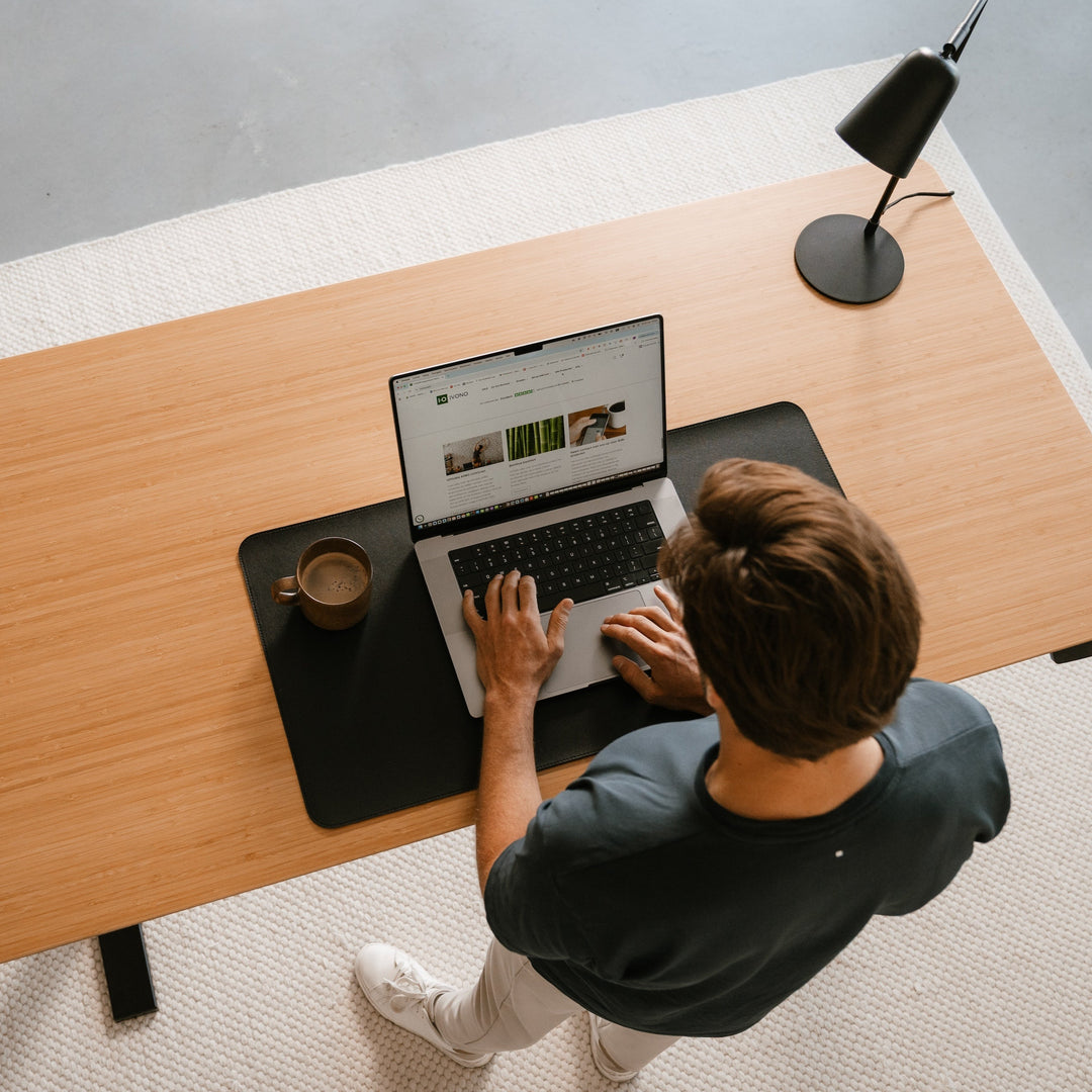 Person using a bamboo standing desk