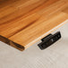 Wooden desk with a digital display showing temperature on a white surface
